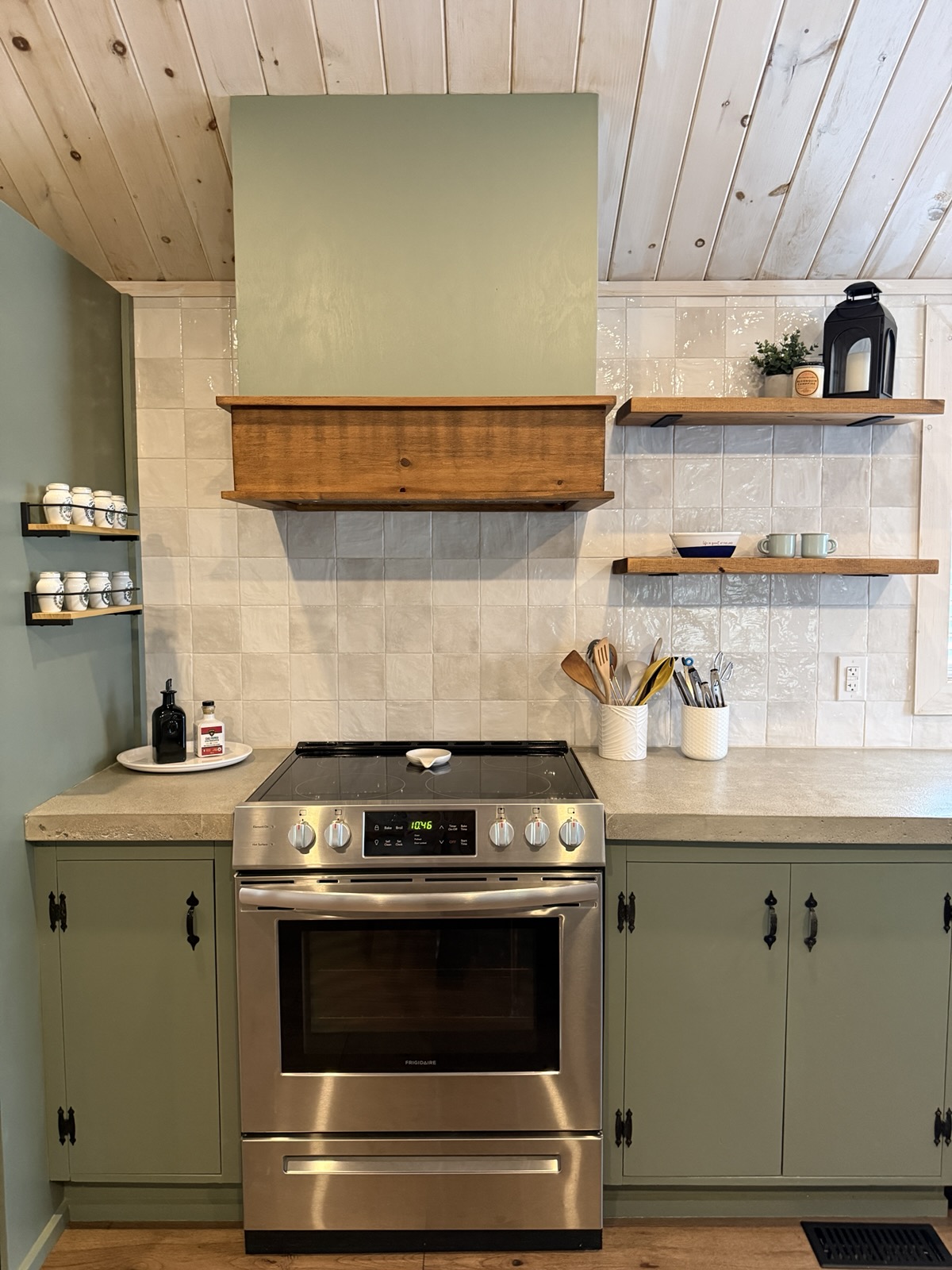 The range wall with open shelves under the pine ceiling