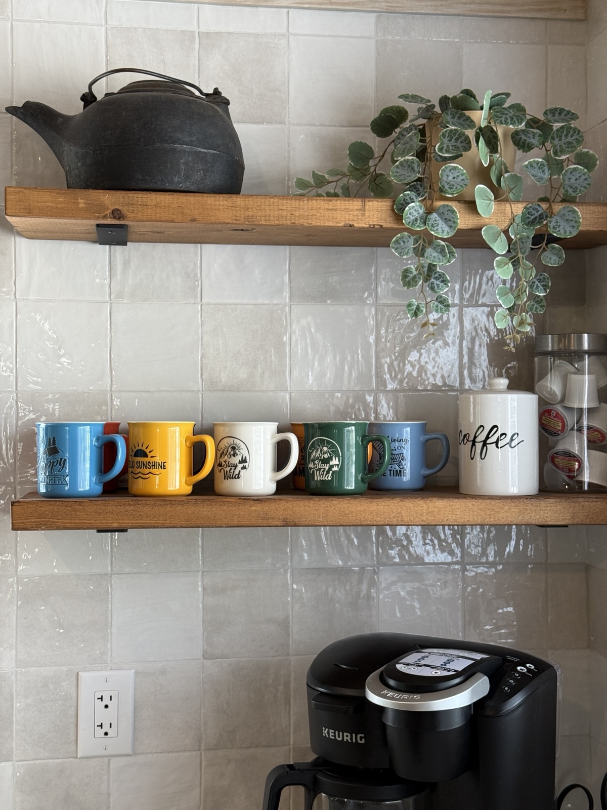 Mugs and the kettle on the open shelves