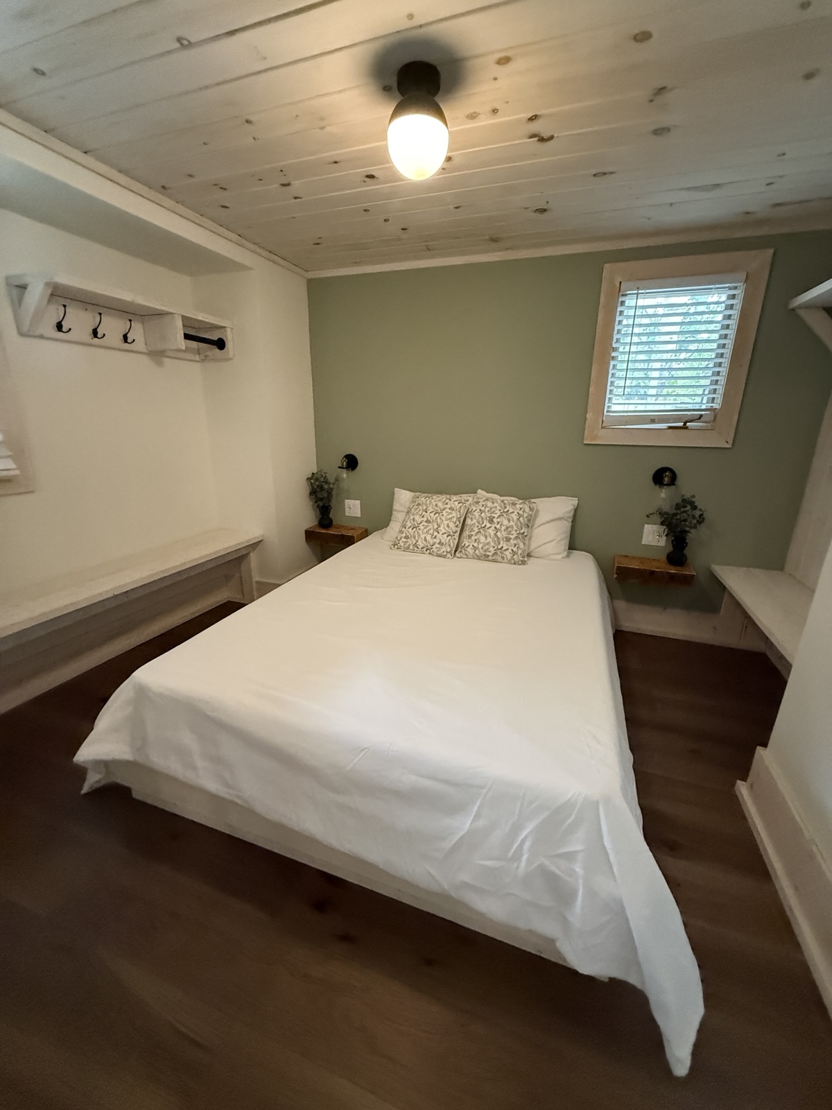 The queen room with hooks and a window over the bed