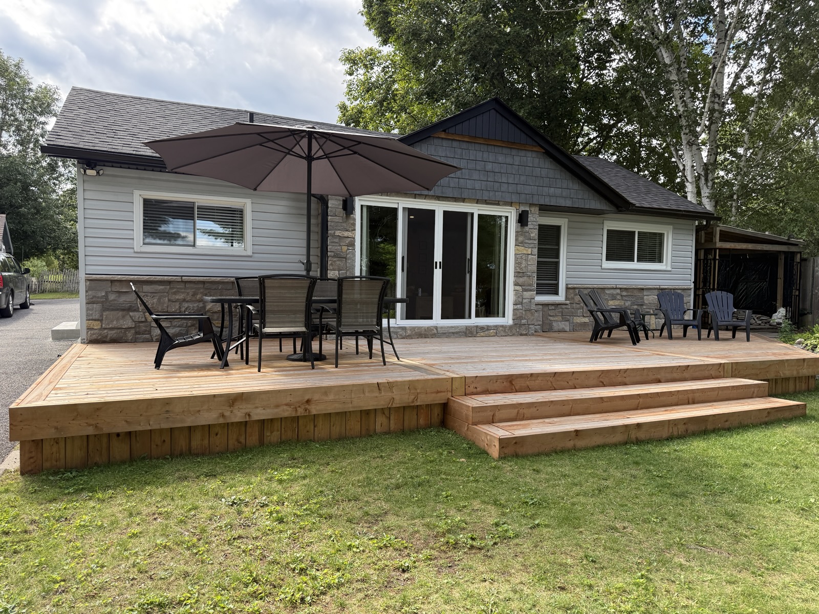 The cottage and its front deck seen from the lawn