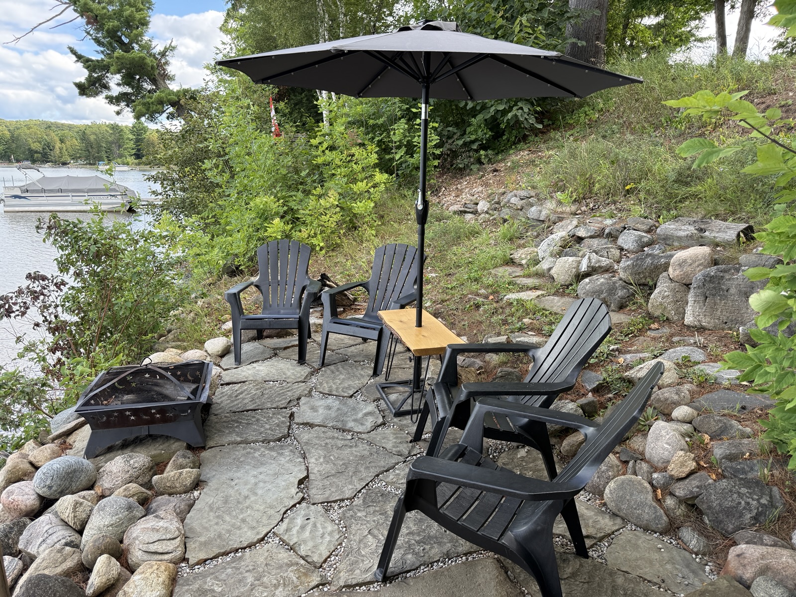 Muskoka chairs and the fire pit at the water