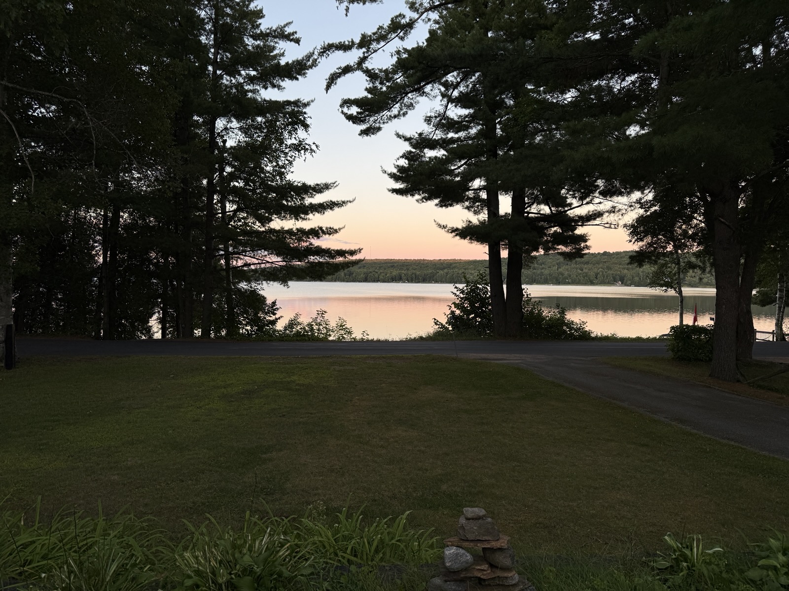 The lawn running down to the lake at dusk